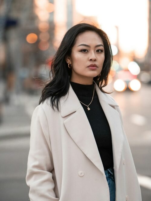 woman in white blazer standing on road during daytime